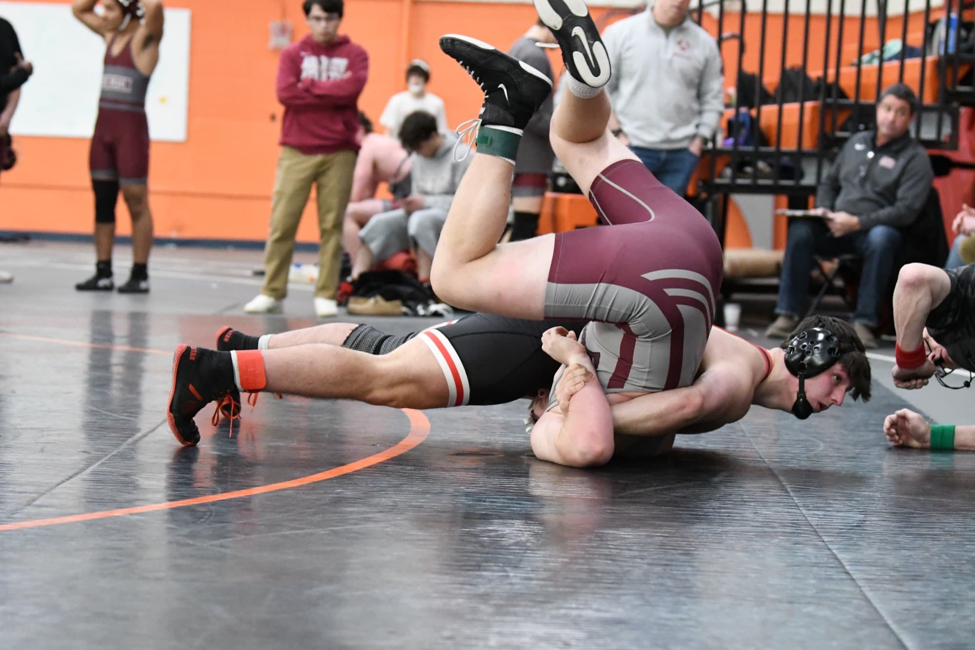 Aiden Aquilina, in North Andover black and scarlet, turning his opponent to his back