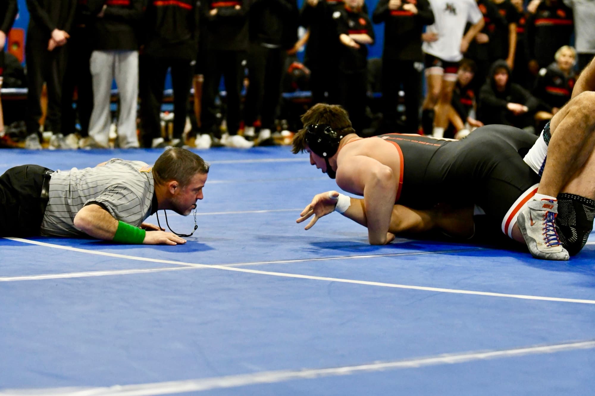 Aiden Aquilina flattening his opponent as the referee drops down to check for the fall